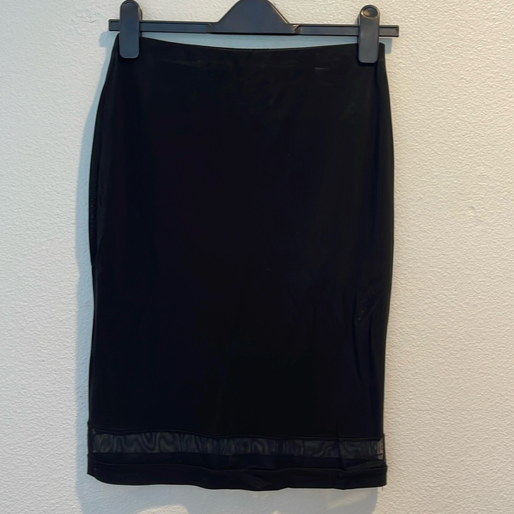 High waisted black skirt with 2” sheer mesh hem. Size XS